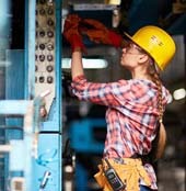 Female HVAC tech working on equipment