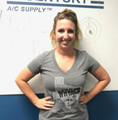 Female HVAC employee showing off their branded shirt