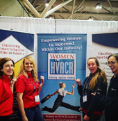 Women in front of WHVACR banner